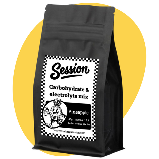 Black package of Session carbohydrate and electrolyte mix with pineapple flavor on a yellow background