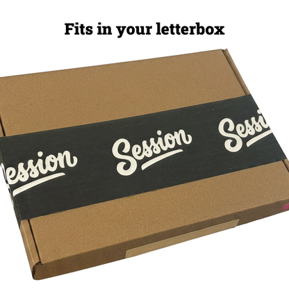 A brown cardboard box with a black paper band around the middle printed with the word 'Session' in white script, shown on a white background with faint fruit illustrations and the text 'Fits in your letterbox' at the top.